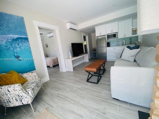 203 Atlantic Boulevard, Unit 203 Key Largo, FL 33037 - Photo 35 of 41 a living room with furniture and a wooden floor