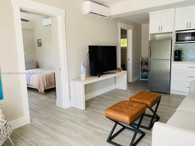 203 Atlantic Boulevard, Unit 203 Key Largo, FL 33037 - Photo 37 of 41 a living room with furniture and a flat screen tv