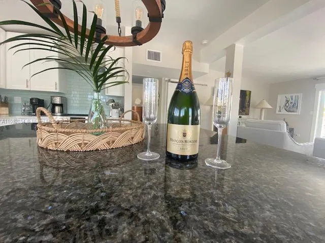 a view of living room kitchen and entryway