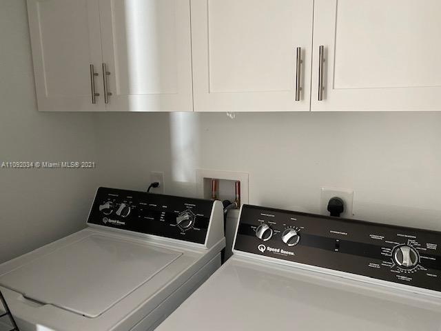 203 Atlantic Boulevard, Unit 203 Key Largo, FL 33037 - Photo 39 of 41 a kitchen with white cabinets and black appliances