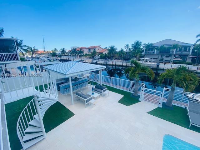 203 Atlantic Boulevard, Unit 203 Key Largo, FL 33037 - Photo 5 of 41 a view of a terrace with furniture and a garden