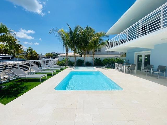 203 Atlantic Boulevard, Unit 203 Key Largo, FL 33037 - Photo 7 of 41 a view of outdoor space yard deck patio and swimming pool