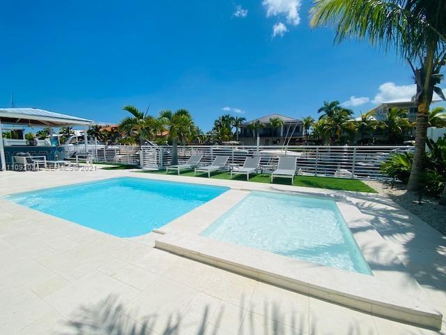 203 Atlantic Boulevard, Unit 203 Key Largo, FL 33037 - Photo 8 of 41 a view of a swimming pool with a patio