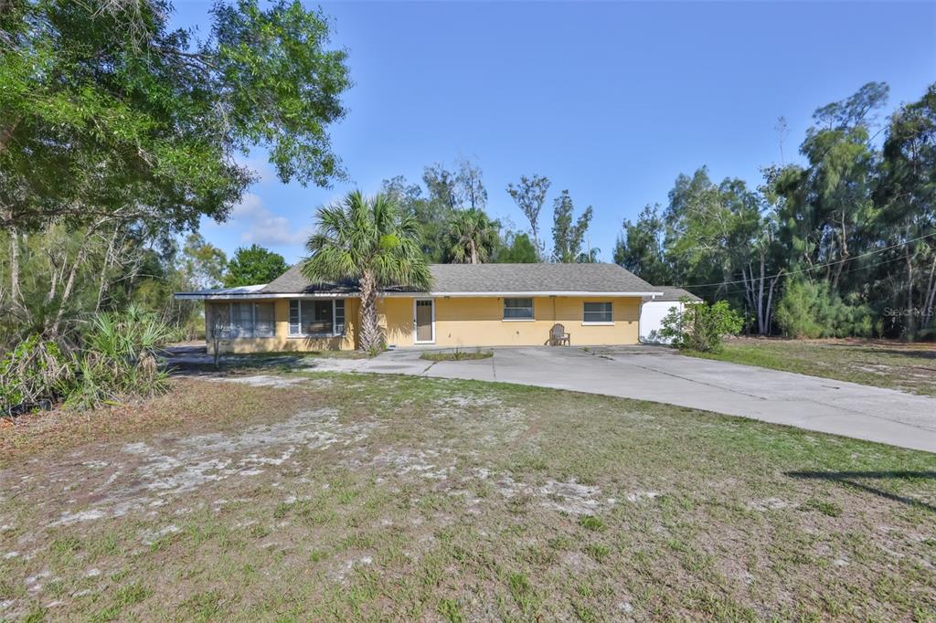 14451 Highland Road Wimauma, FL 33598 - Photo 6 of 80 a front view of a house with a yard