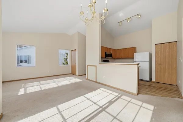 a view of a kitchen with a sink and a refrigerator