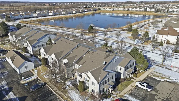 an aerial view of a house with a lake view