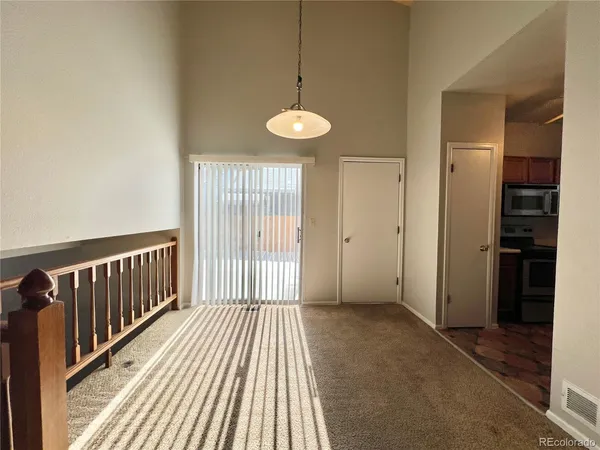 a view of a room with wooden floor