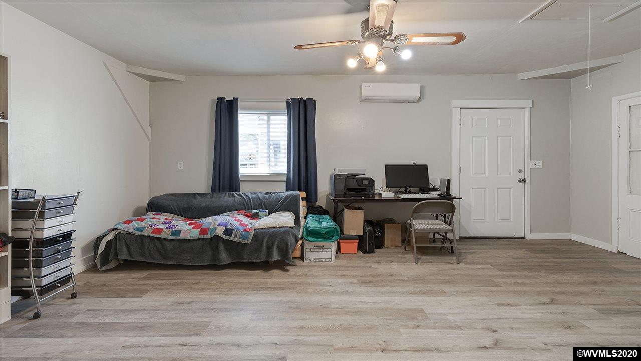790 Southeast Fir Villa Road Dallas, OR 97338 - Photo 34 of 38 a bedroom with furniture and a flat screen tv