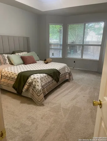 a bedroom with a bed and window