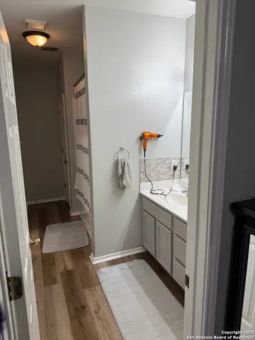 a bathroom with a sink and mirror
