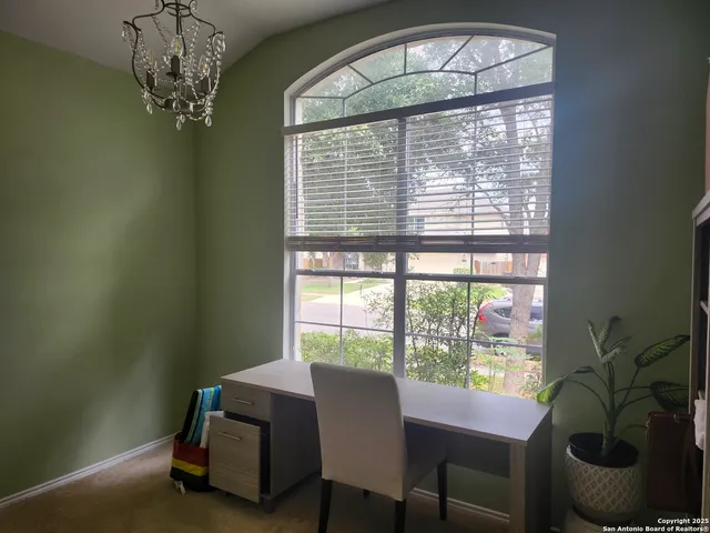 a dining room with furniture and a chandelier