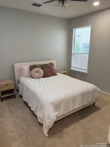 a bedroom with a bed and window