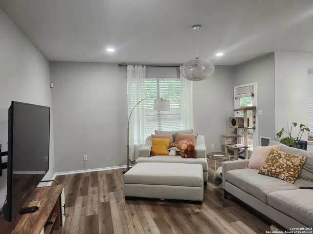 a bedroom with furniture and a flat screen tv