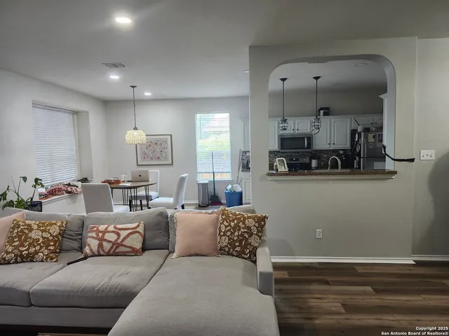 a living room with furniture and kitchen view