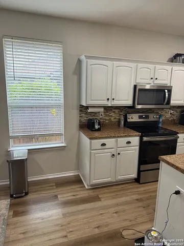 a kitchen with a stove and a microwave