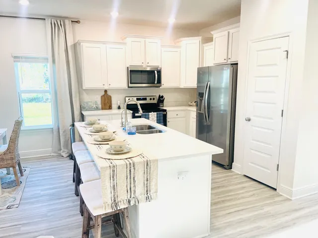 a large bed sitting in a bedroom next to a window