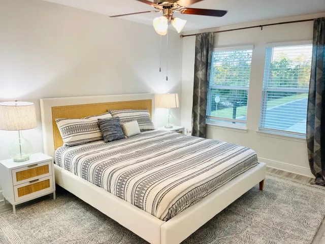 a bathroom with a sink a mirror and a potted plant