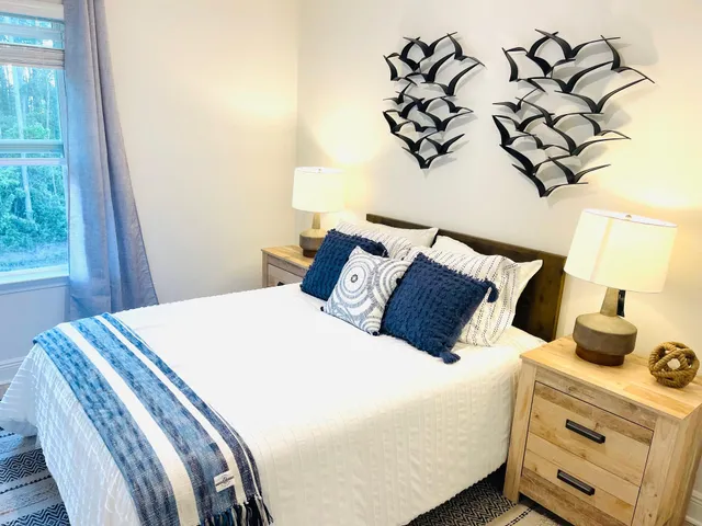 a bedroom with a bed and a night stand