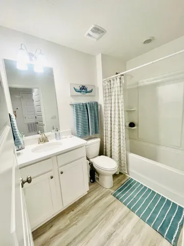 a large bed sitting in a bedroom next to a window