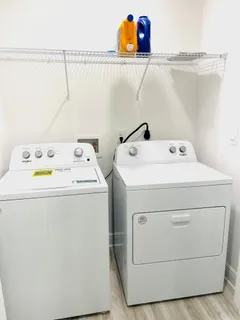 a view of a house with a yard and sitting area