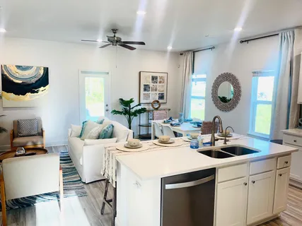 a living room with furniture and a potted plant