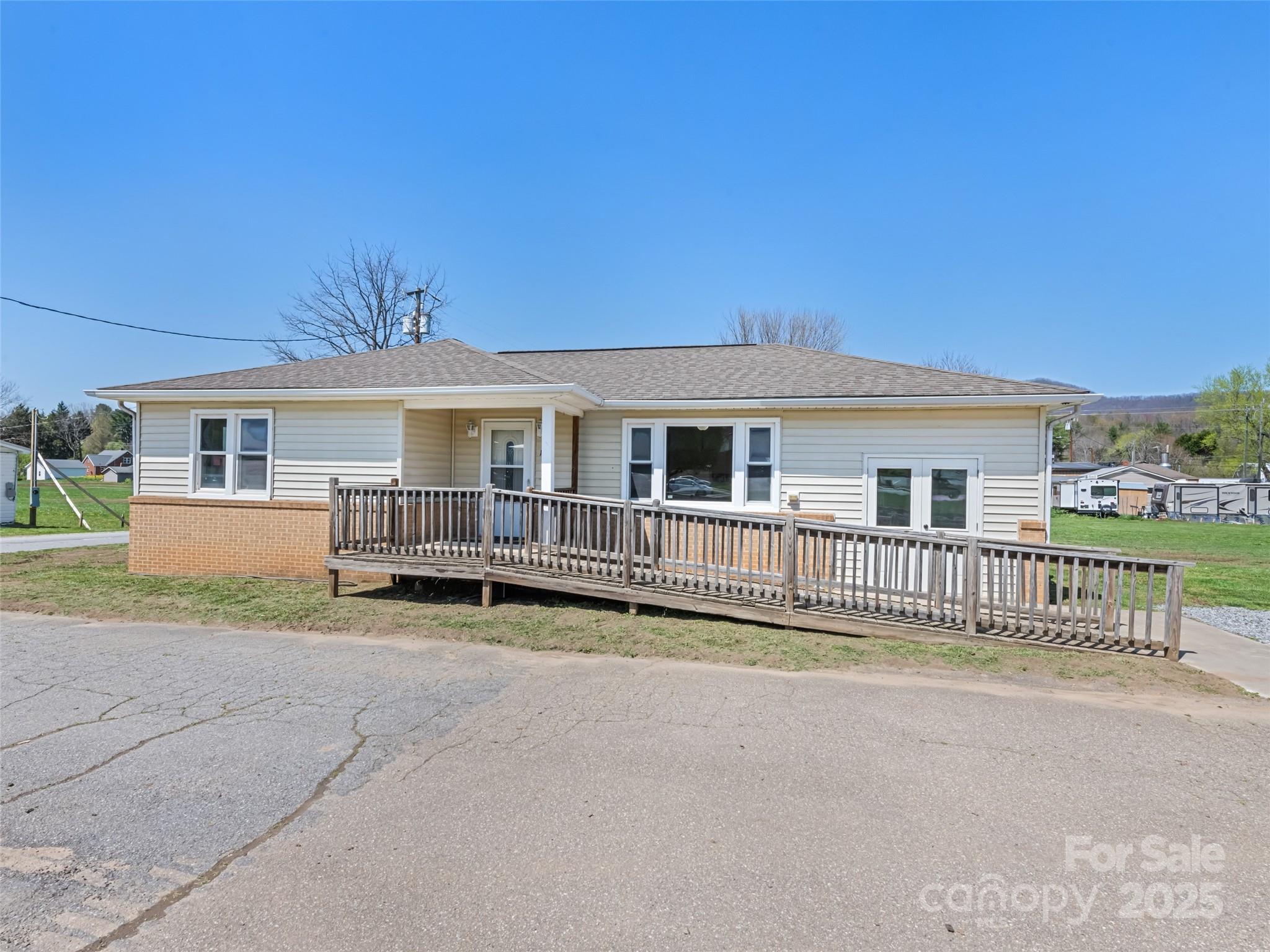a view of a house with wooden fence next to a road