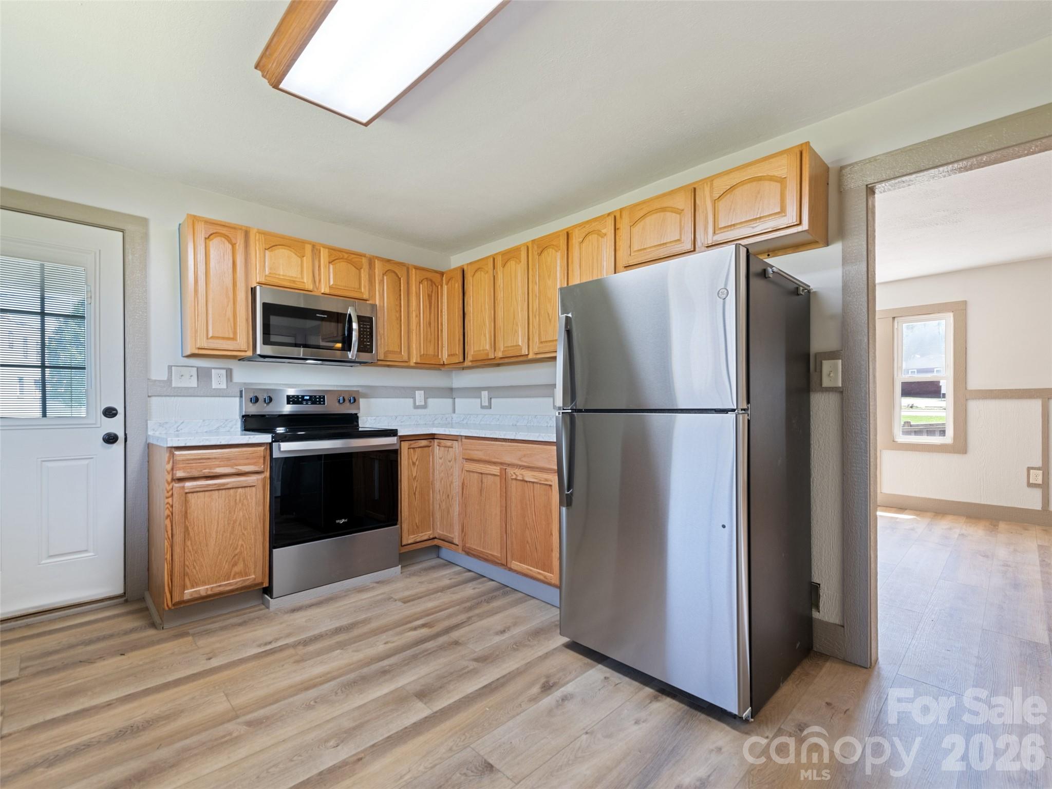 13 Depot Street Clyde, NC 28721 - Photo 11 of 21 a kitchen with a refrigerator and a microwave