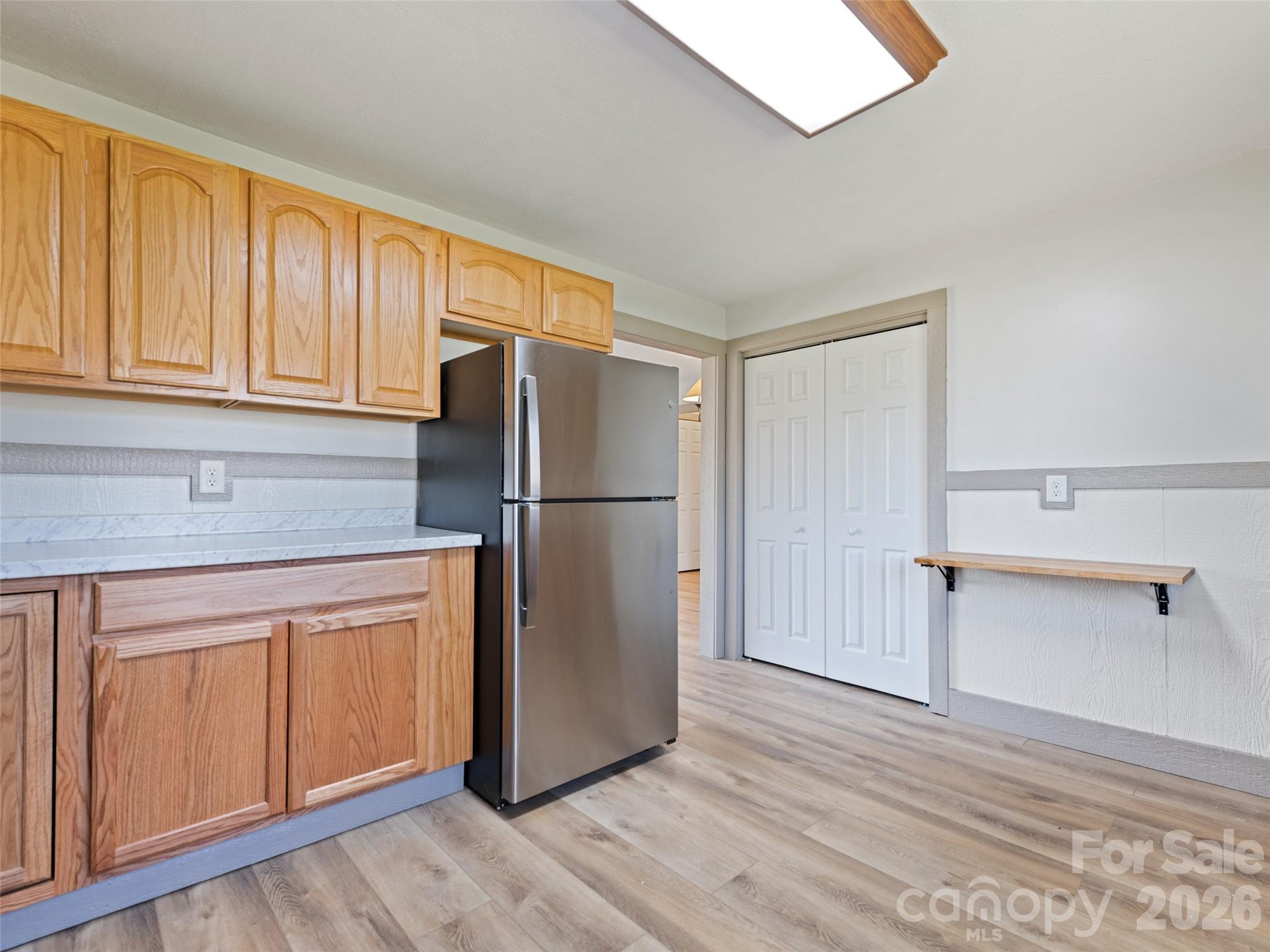 13 Depot Street Clyde, NC 28721 - Photo 12 of 21 a kitchen with a refrigerator sink and cabinets