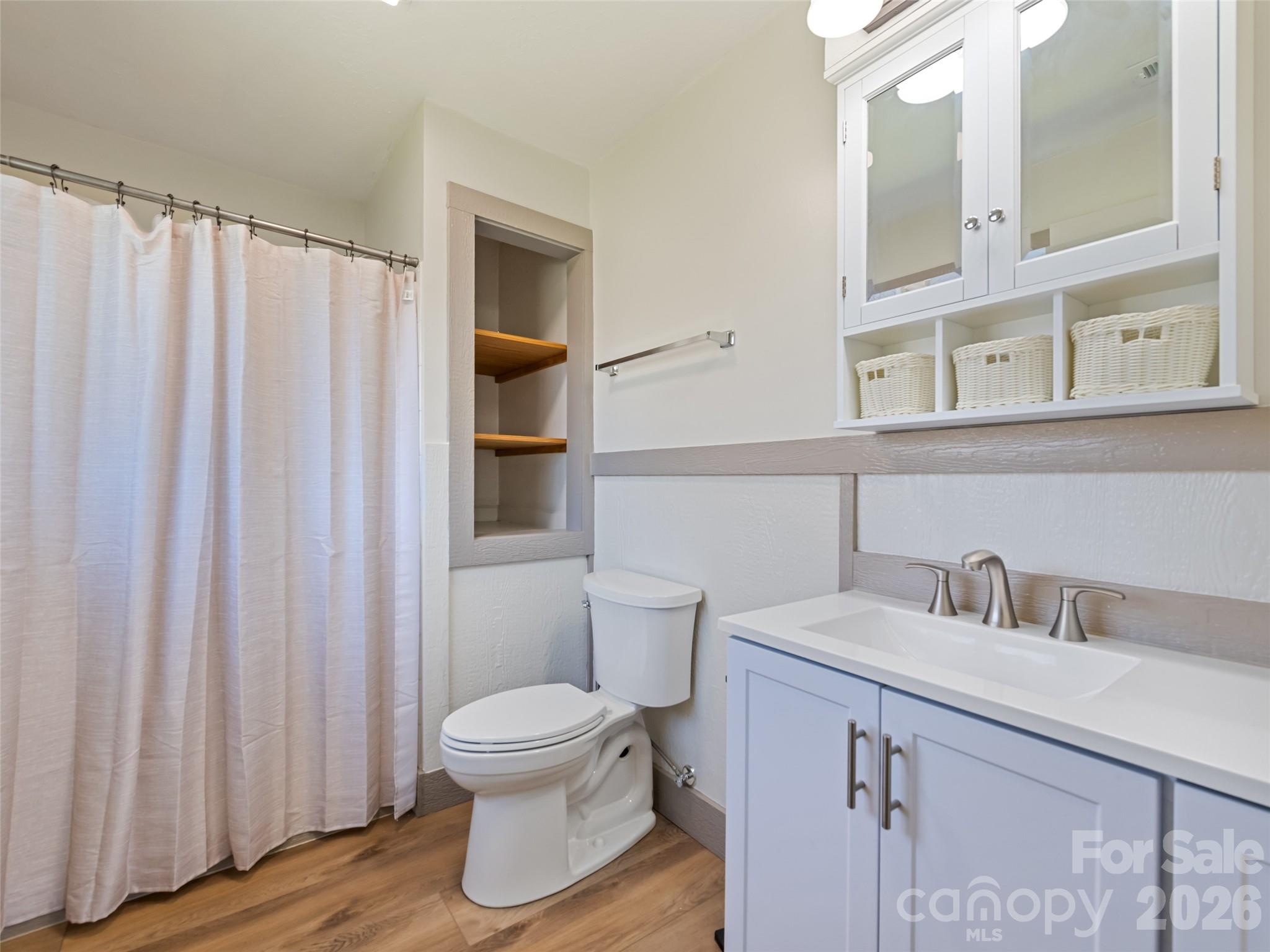 13 Depot Street Clyde, NC 28721 - Photo 13 of 21 a bathroom with a sink and a mirror