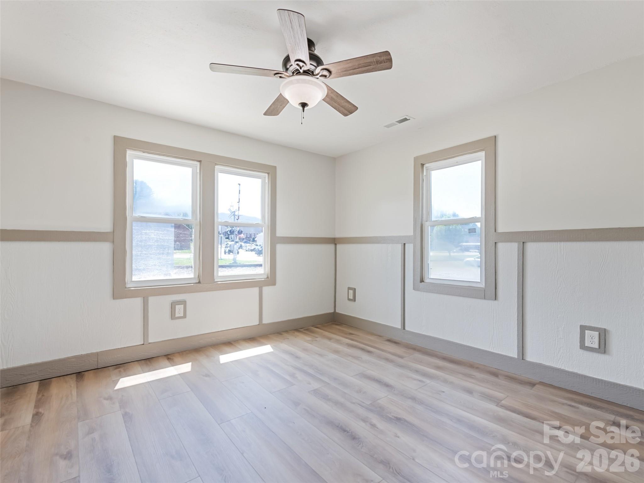 13 Depot Street Clyde, NC 28721 - Photo 14 of 21 a view of an empty room with a window and wooden floor