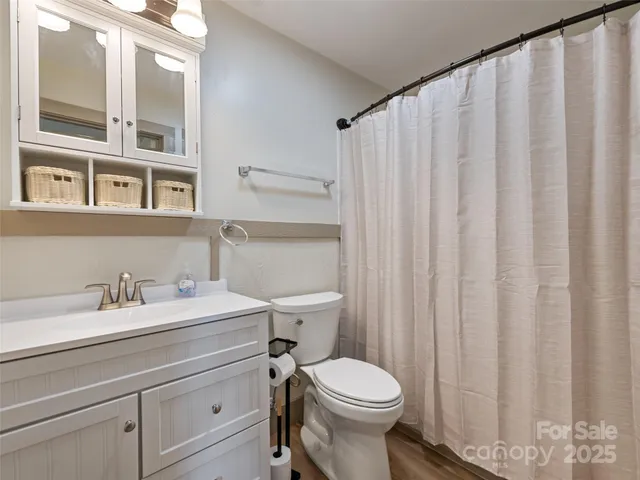 a bathroom with a toilet a sink and a mirror