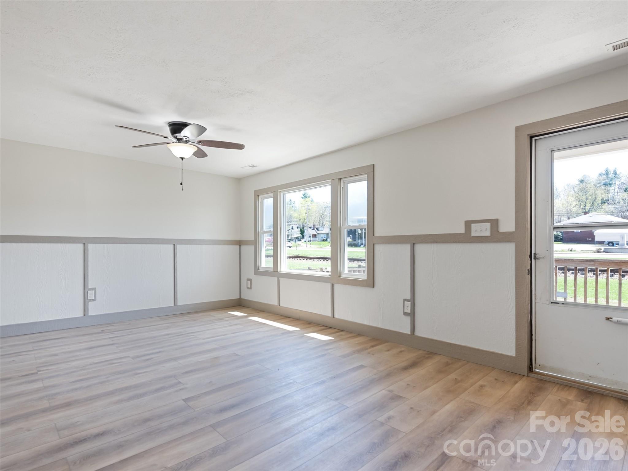 13 Depot Street Clyde, NC 28721 - Photo 17 of 21 a view of an empty room with a window and wooden floor