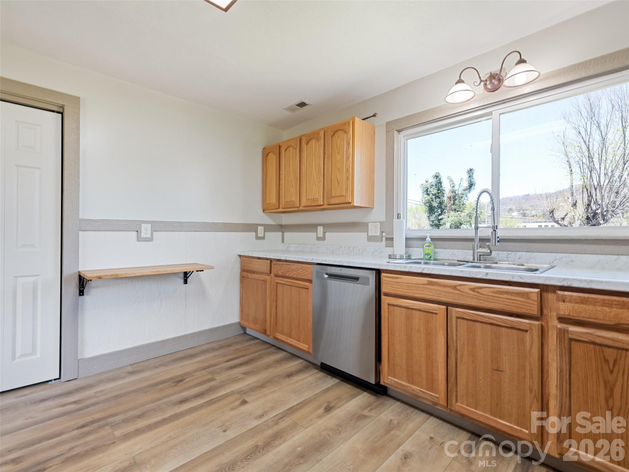 13 Depot Street Clyde, NC 28721 - Photo 18 of 21 a kitchen with wooden cabinets and sink