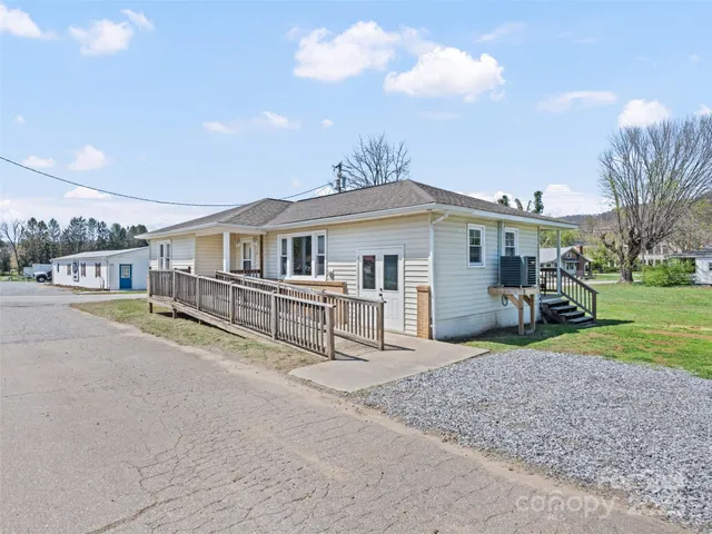 a view of a house with a yard and sitting area