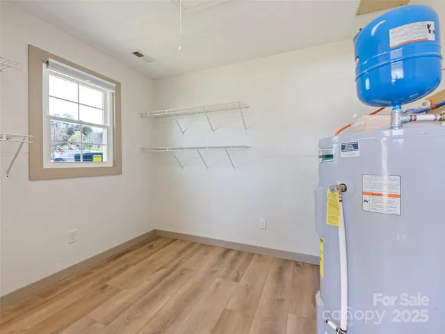 a view of storage and utility room with a window
