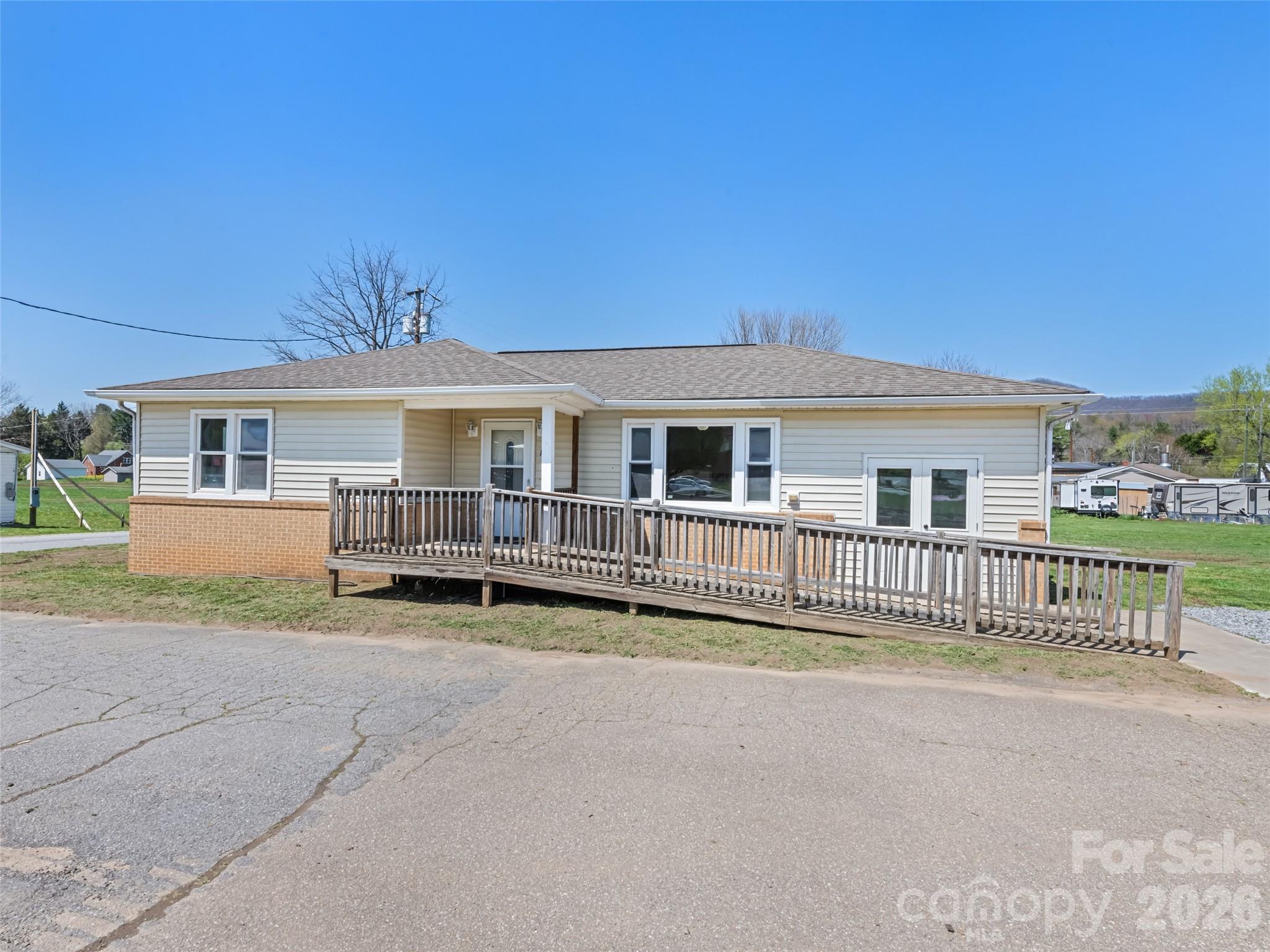 13 Depot Street Clyde, NC 28721 - Photo 3 of 21 a view of a house with wooden fence next to a road