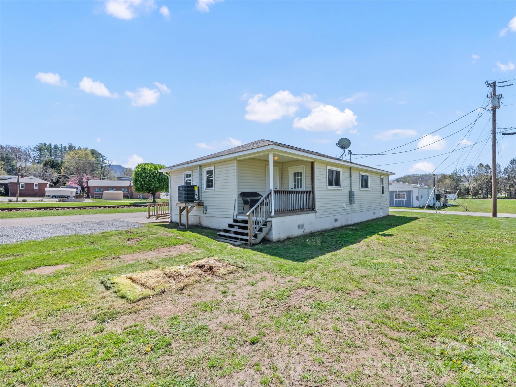 13 Depot Street Clyde, NC 28721 - Photo 4 of 21 a view of a house with backyard and sitting area