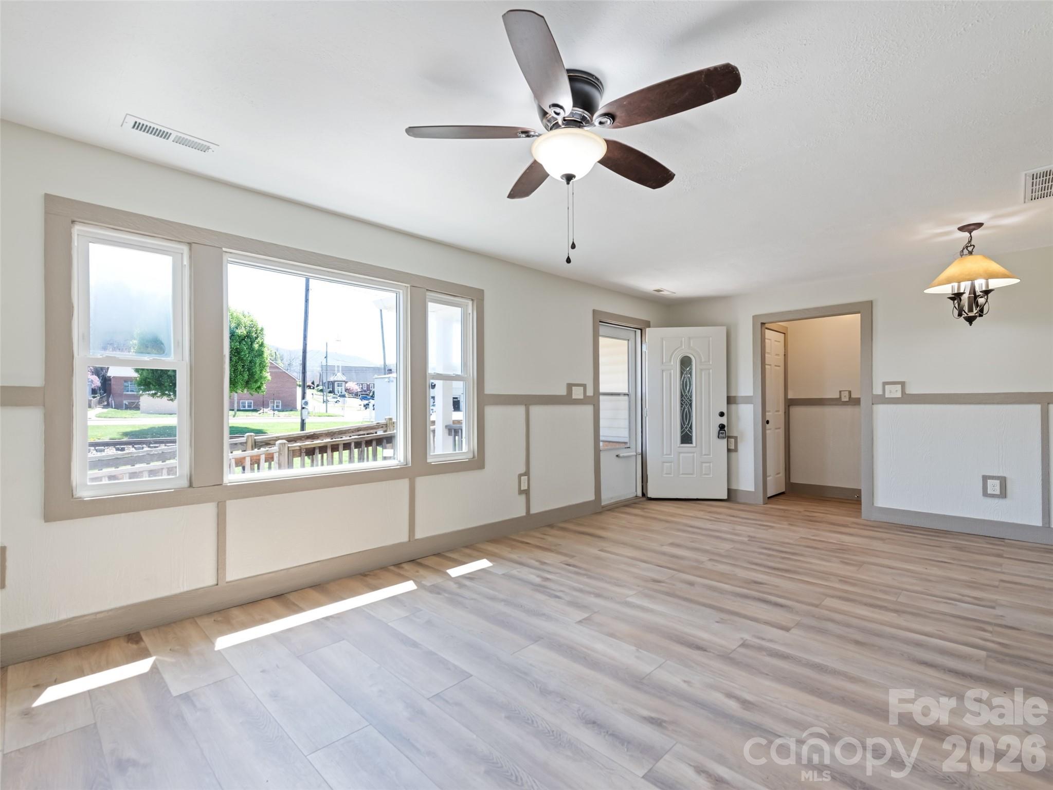 13 Depot Street Clyde, NC 28721 - Photo 9 of 21 a view of an empty room with a window and wooden floor