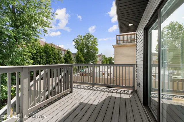 a view of balcony with wooden floor