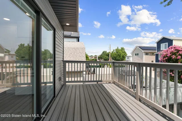 a view of a balcony with wooden floor