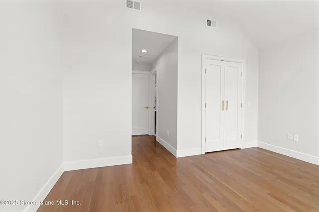 an empty room with wooden floor