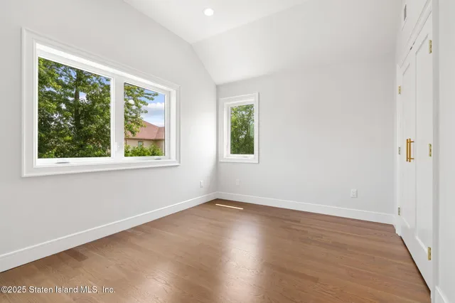 a view of a room with wooden floor and windows