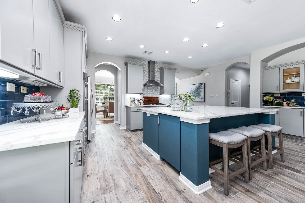 12107 Bayou Junction Road Cypress, TX 77433 - Photo 16 of 45 Nothing is lacking in this updated kitchen ... the cabinet door in the island hides a pop up shelf you can use for your kitchen stand mixer to use without the inconvenience of lugging it to the counter.