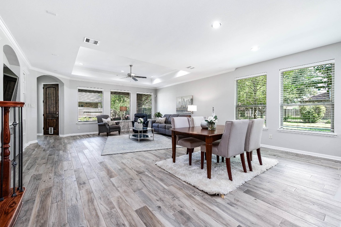 12107 Bayou Junction Road Cypress, TX 77433 - Photo 17 of 45 Open concept is the key feature in the breakfast area and den area. Look at all the windows and natural light flooding in.