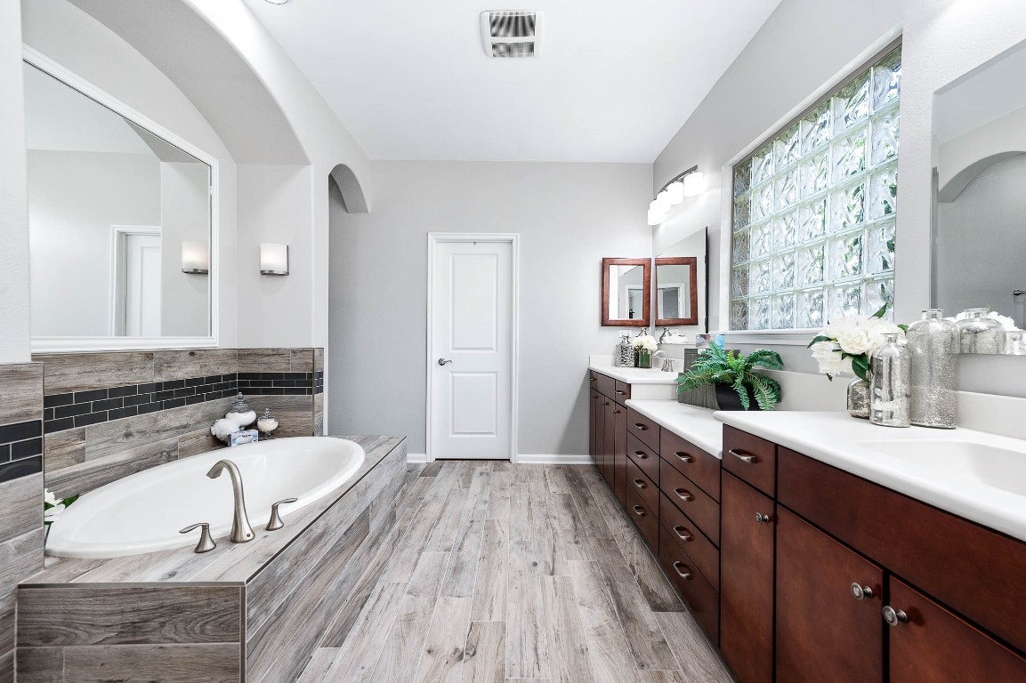 12107 Bayou Junction Road Cypress, TX 77433 - Photo 28 of 45 Primary bath is a great size with double sinks, tons of cabinets, large soaking tub and walk in shower.