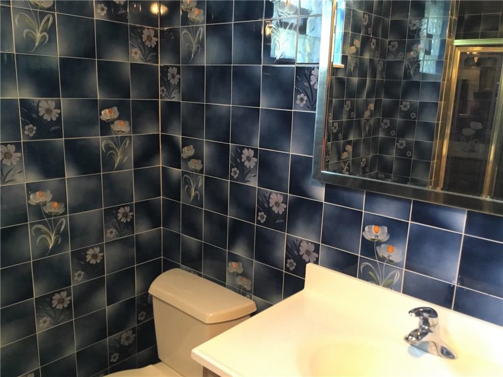 4138 Beehner Road Pittsburgh, PA 15217 - Photo 17 of 22 Second full bath in the lower level. Shower door can be seen in the mirror.