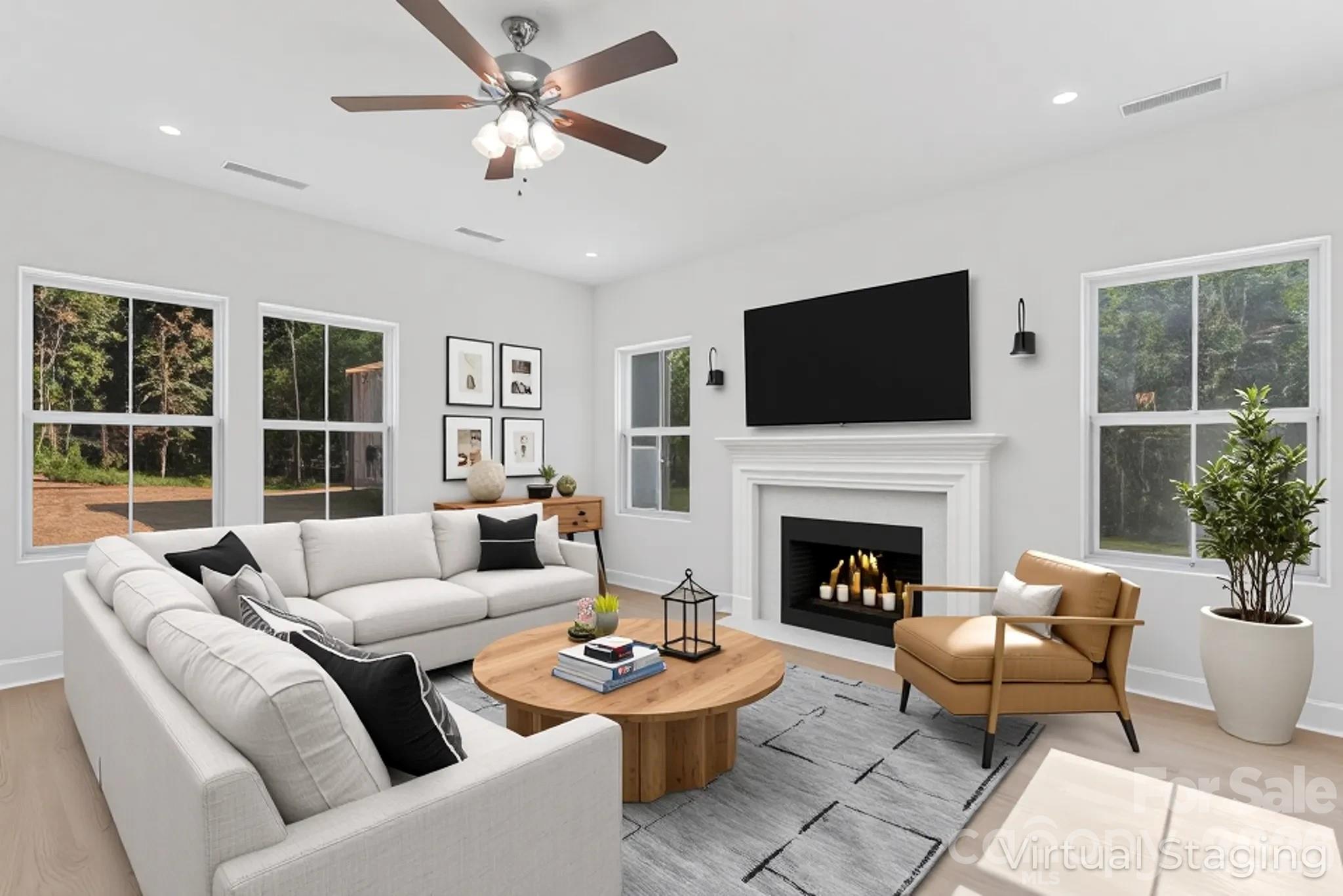 a living room with furniture a fireplace and a flat screen tv