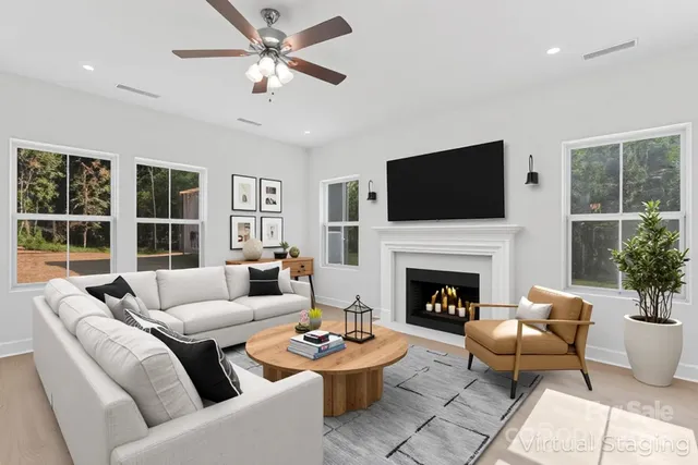 a living room with furniture a fireplace and a flat screen tv