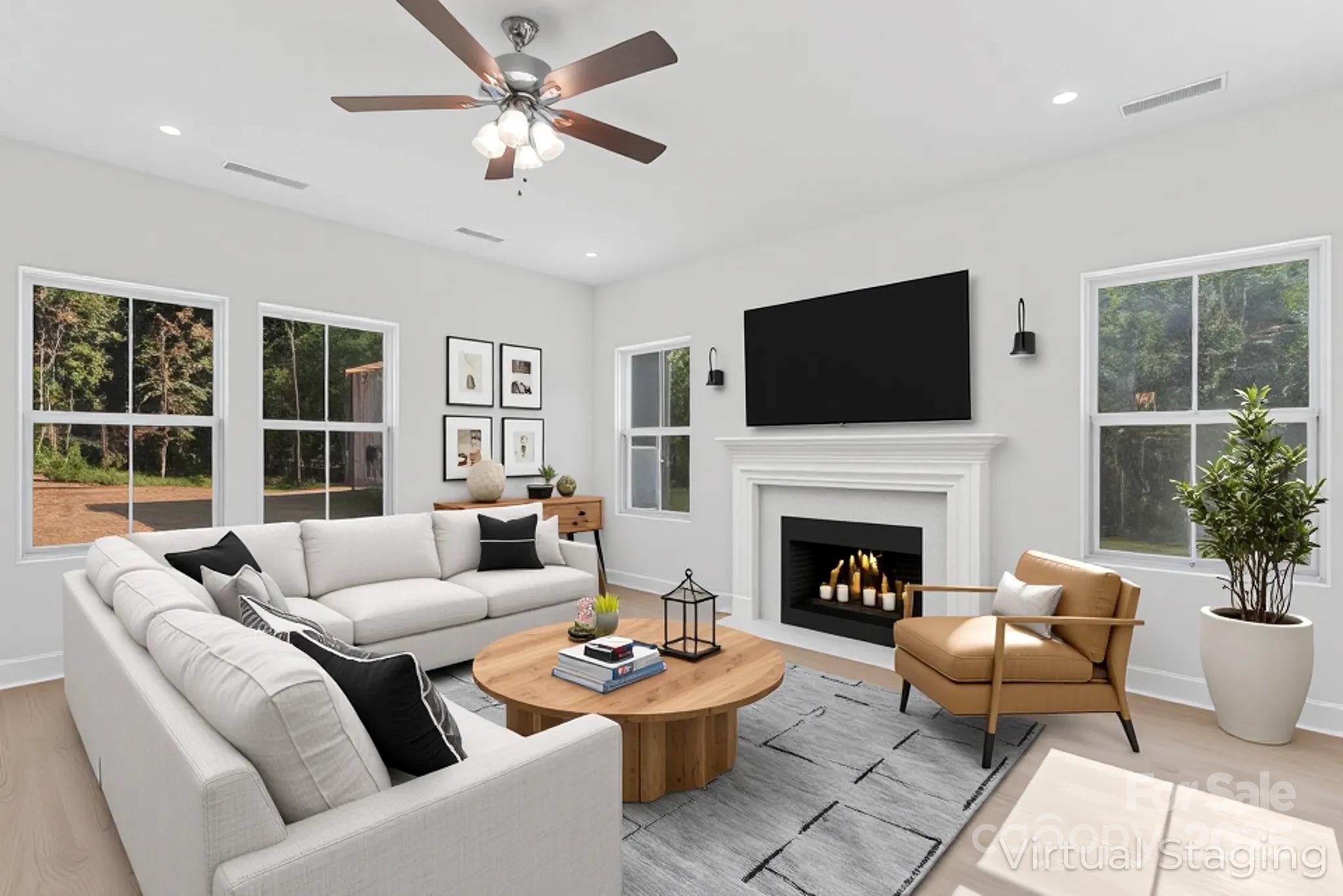 a living room with furniture a fireplace and a flat screen tv