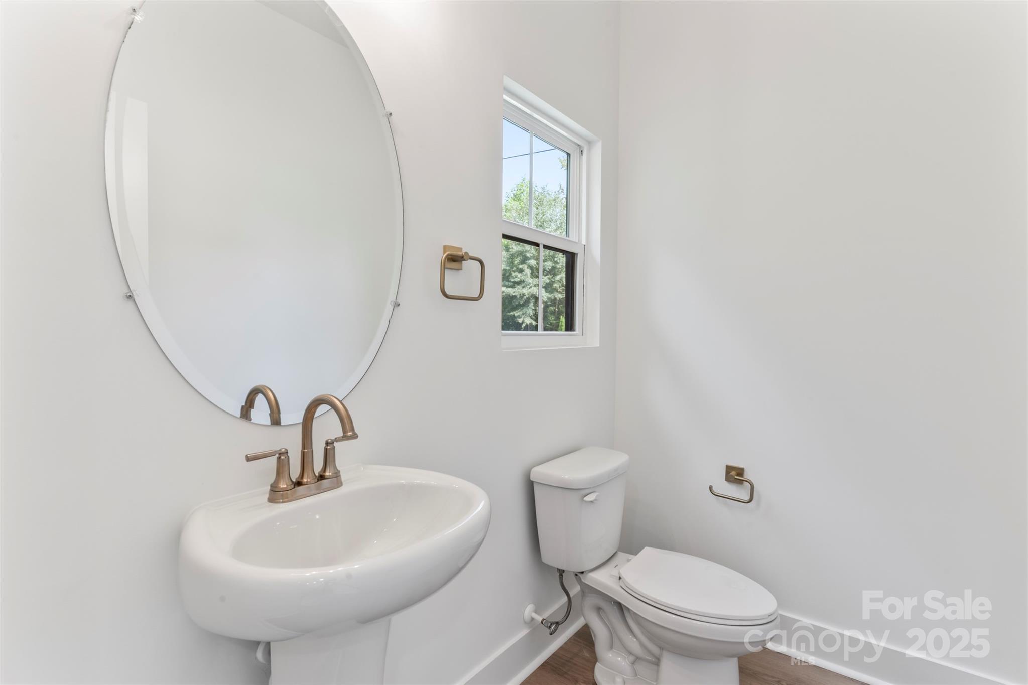 309 Yaupon Court, Unit 17 Fort Mill, SC 29708 - Photo 11 of 43 a bathroom with a sink a toilet and mirror